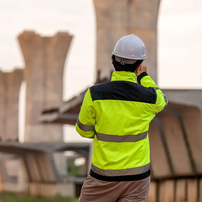 United States Pressure Grouting Administration Technical Advisor looking out over a highway bridge construction site